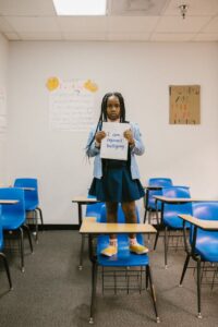 girl holding a notebook saying i am against bullying